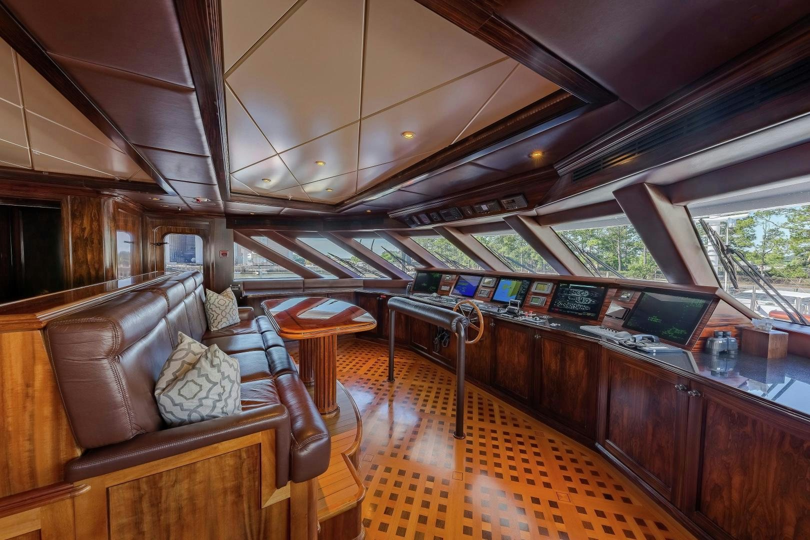a large living room with wood furniture aboard UNBRIDLED Yacht for Sale