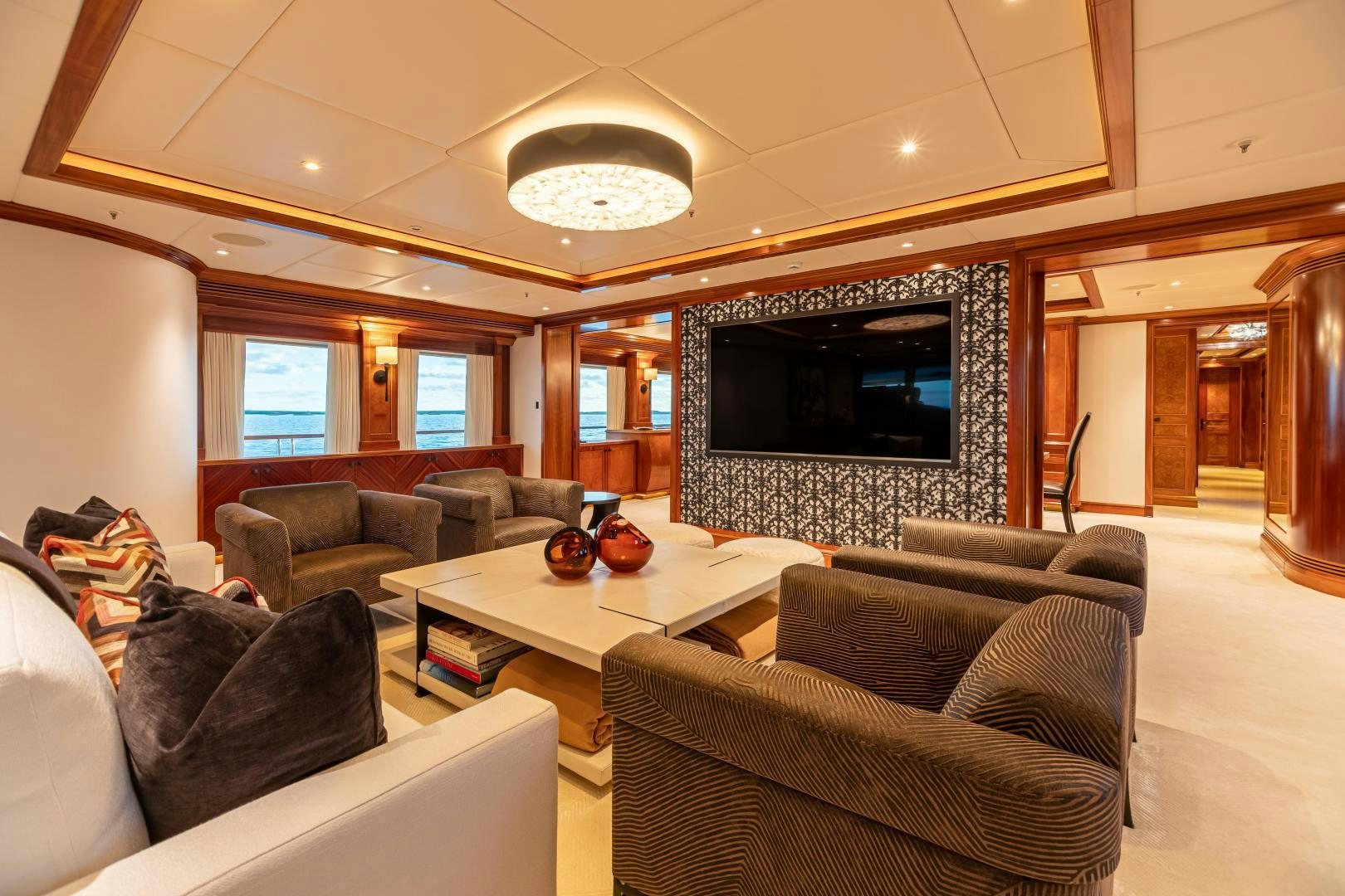 a living room with a large screen aboard UNBRIDLED Yacht for Sale