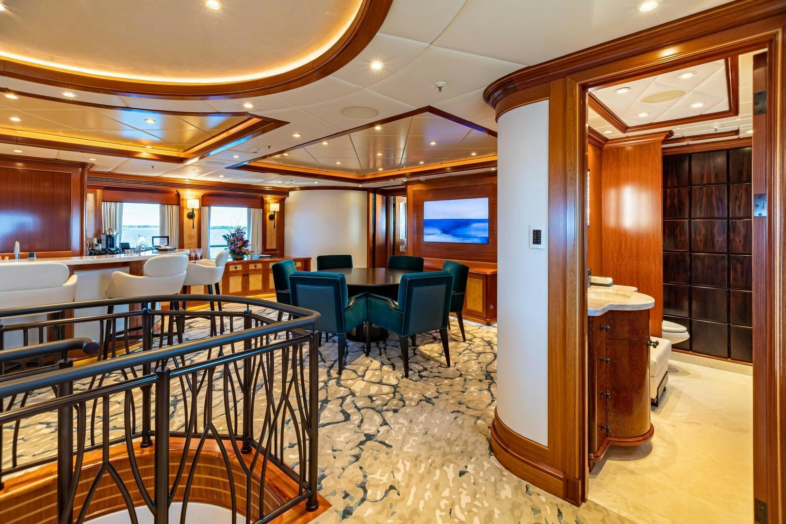a large room with tables and chairs aboard UNBRIDLED Yacht for Sale