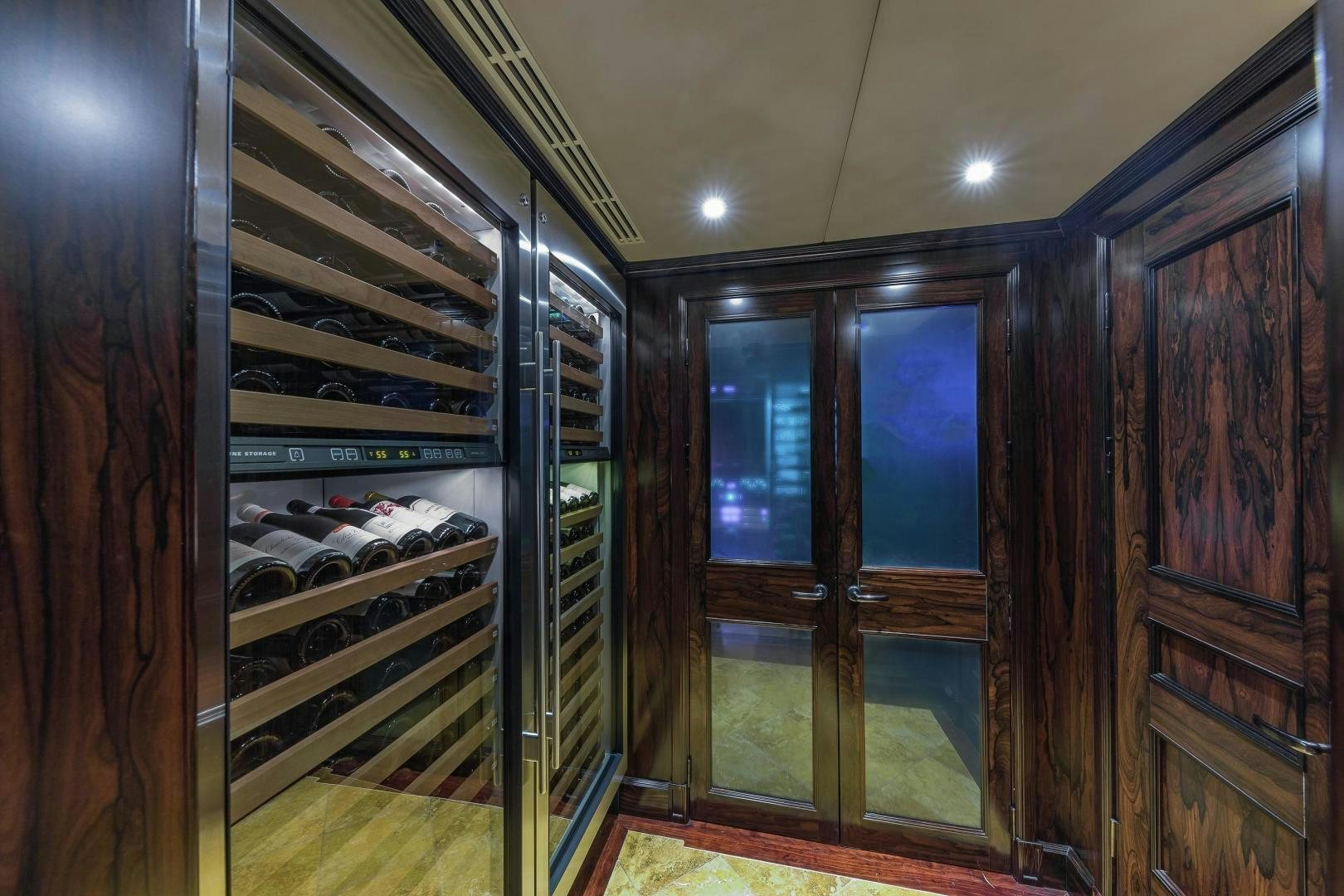 a room with wooden cabinets aboard UNBRIDLED Yacht for Sale