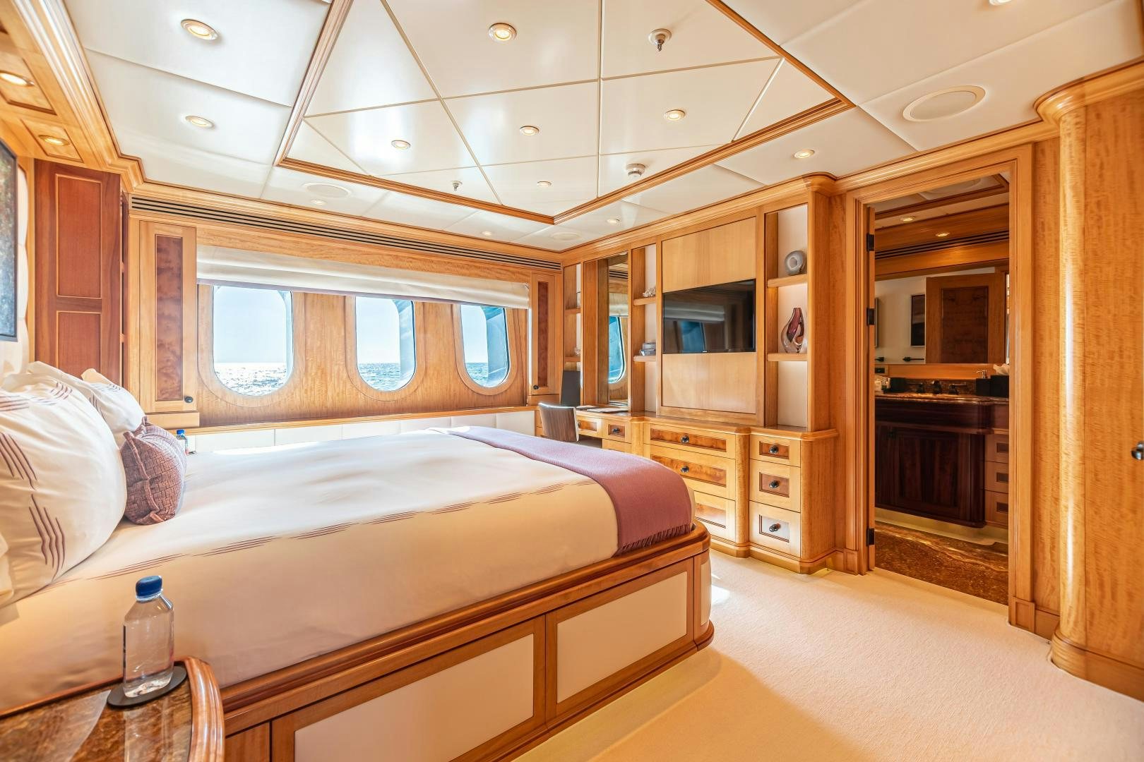 a bedroom with a bed and a desk aboard UNBRIDLED Yacht for Sale