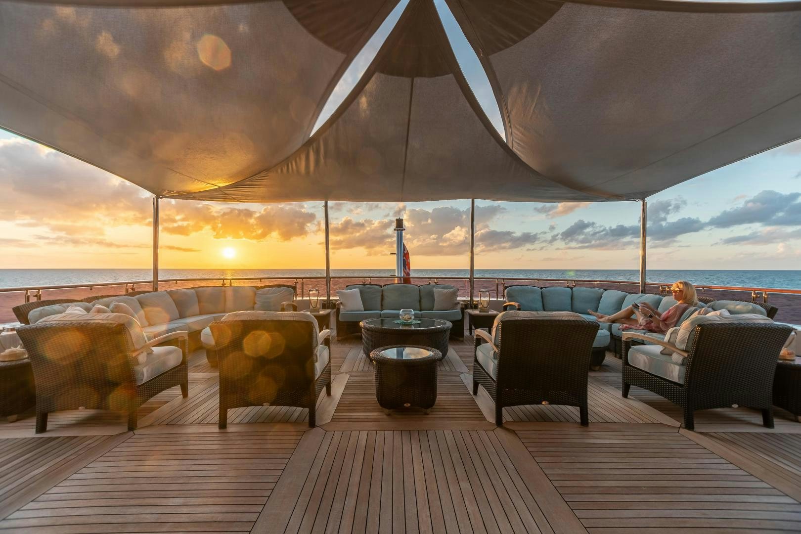 a large lounge area with a large patio and a large building with a view of the water and aboard UNBRIDLED Yacht for Sale