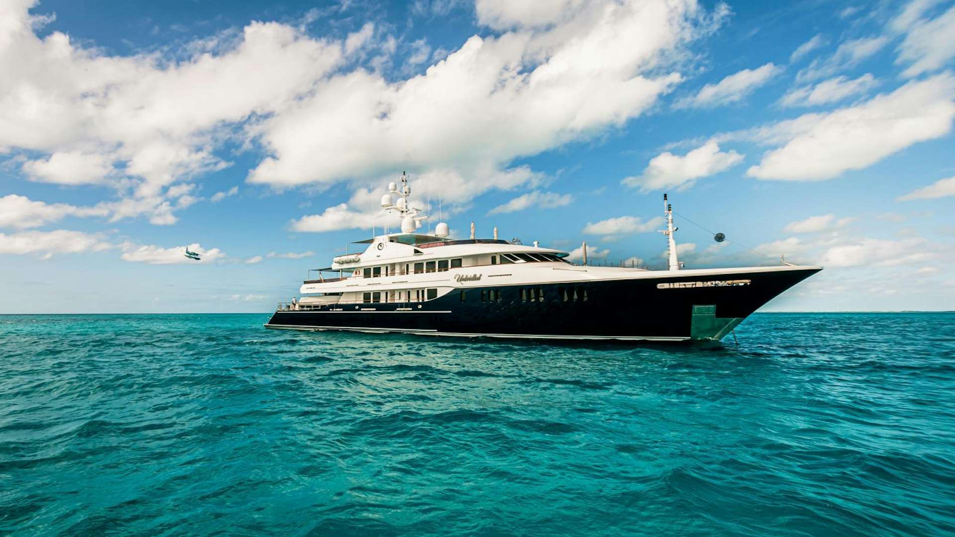 a large ship in the water aboard Unbridled Yacht for Sale