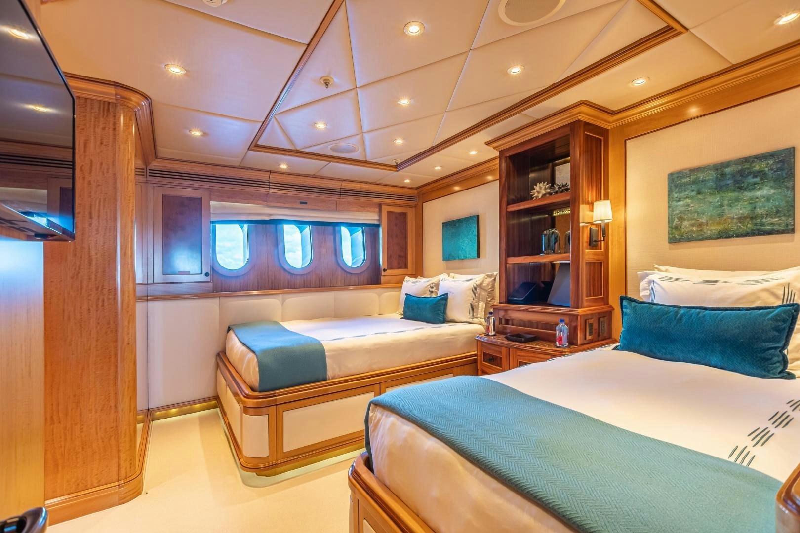 a room with a couple beds aboard UNBRIDLED Yacht for Sale