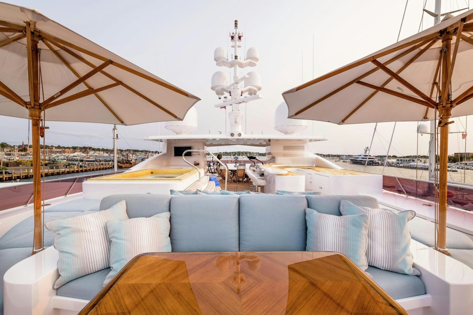 a large lounge area with a large white ceiling and a large white chandelier aboard UNBRIDLED Yacht for Sale