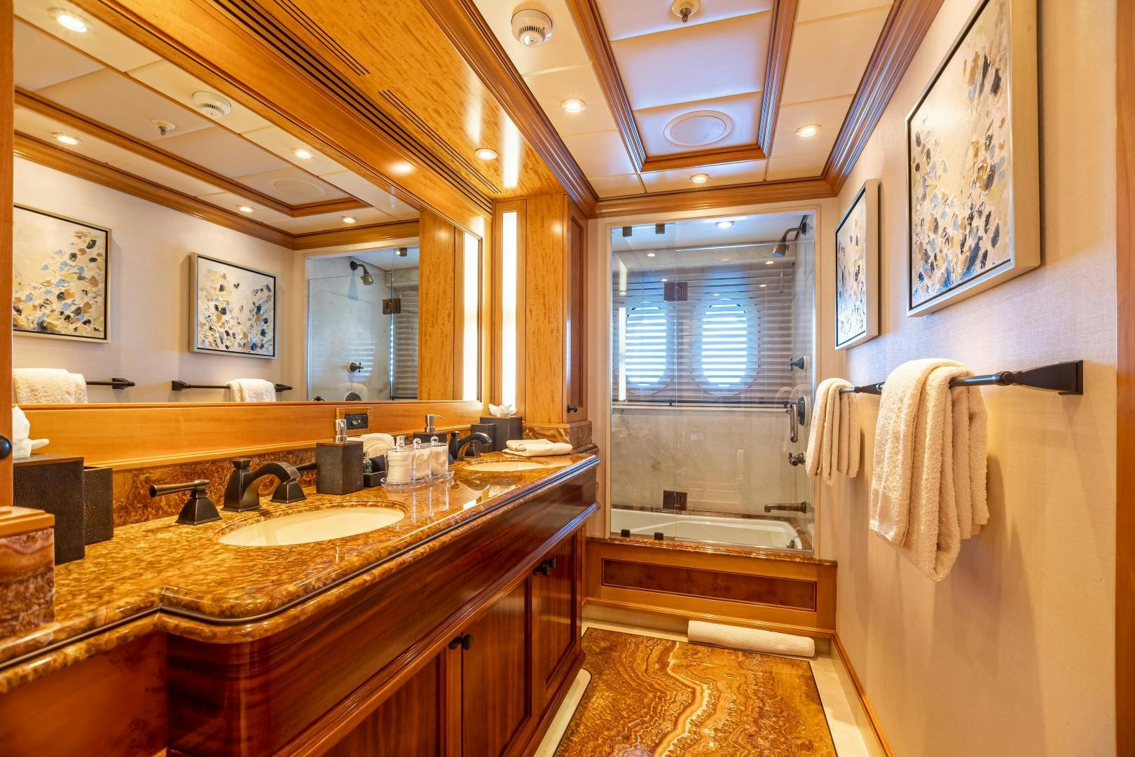 a bathroom with a countertop sink and a large mirror aboard UNBRIDLED Yacht for Sale