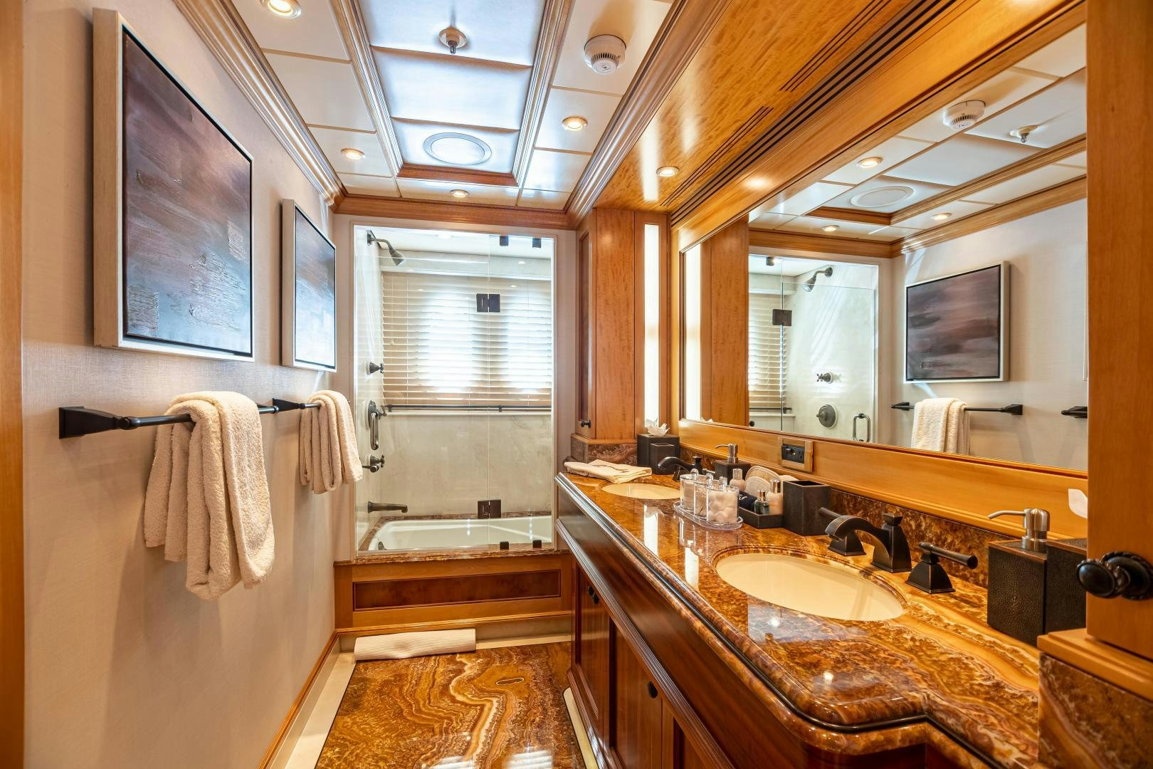 a bathroom with a large mirror aboard UNBRIDLED Yacht for Sale