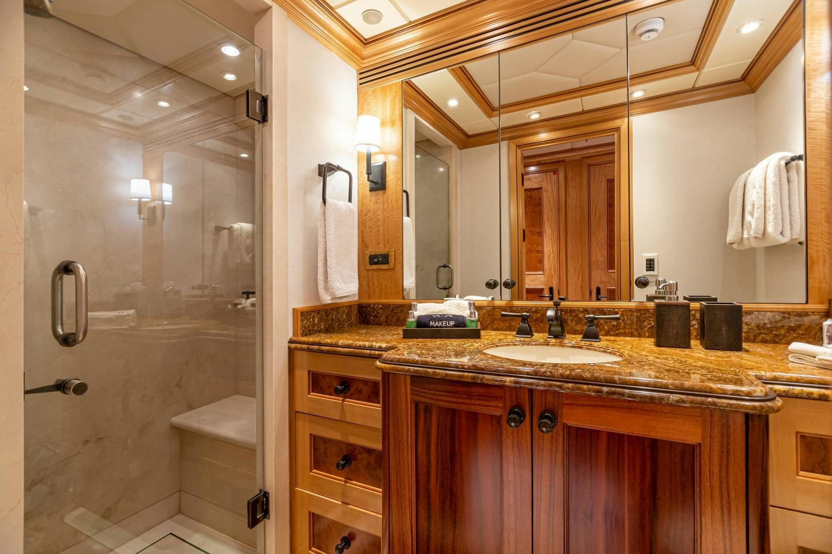 a bathroom with a large mirror aboard UNBRIDLED Yacht for Sale