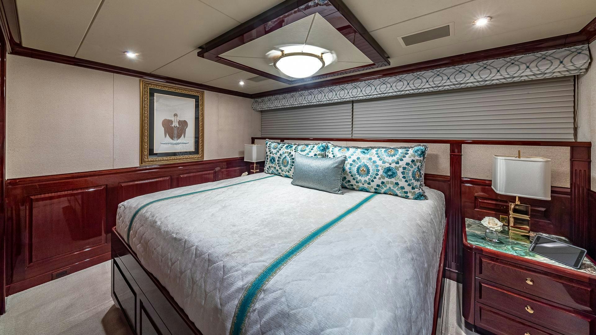 a bedroom with a bed and a desk aboard CASINO ROYALE Yacht for Sale