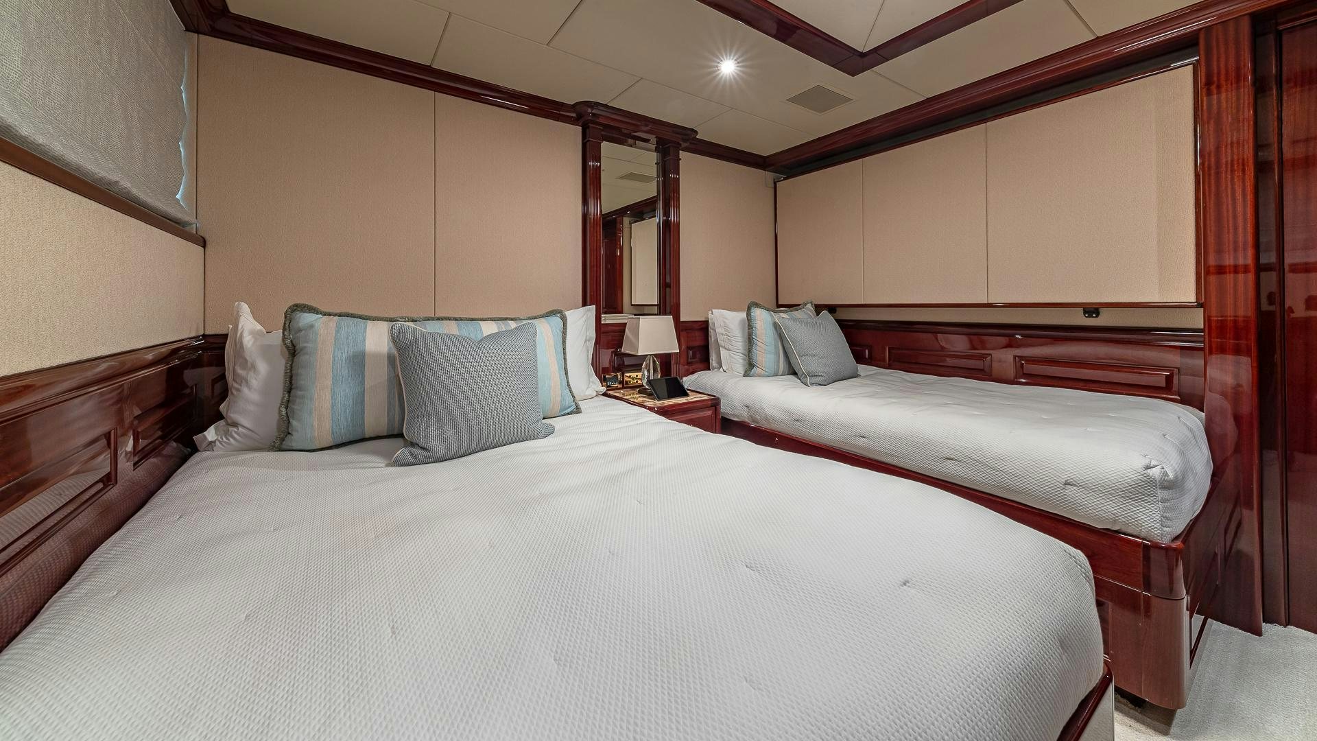 a couple of beds in a hotel room aboard CASINO ROYALE Yacht for Sale