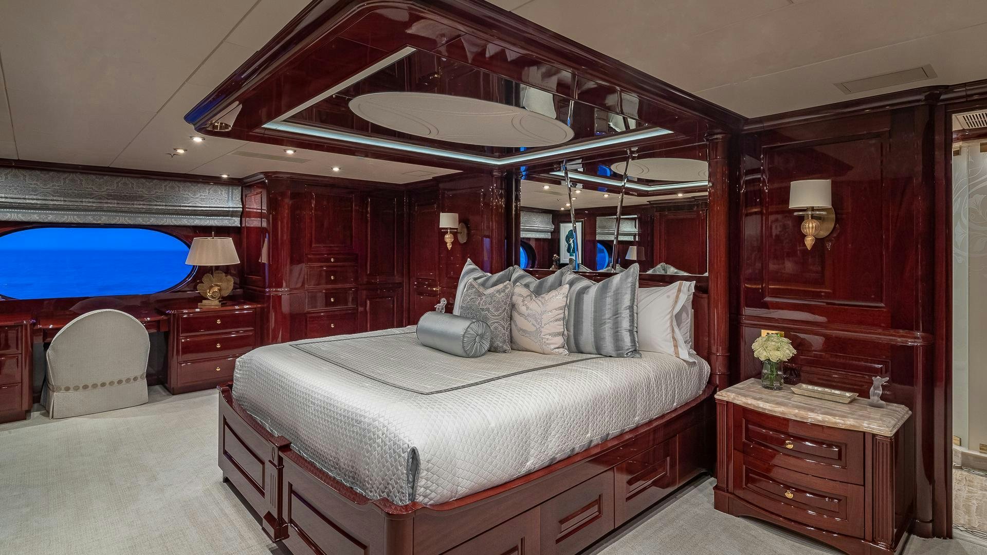 a bedroom with a large bed aboard CASINO ROYALE Yacht for Sale