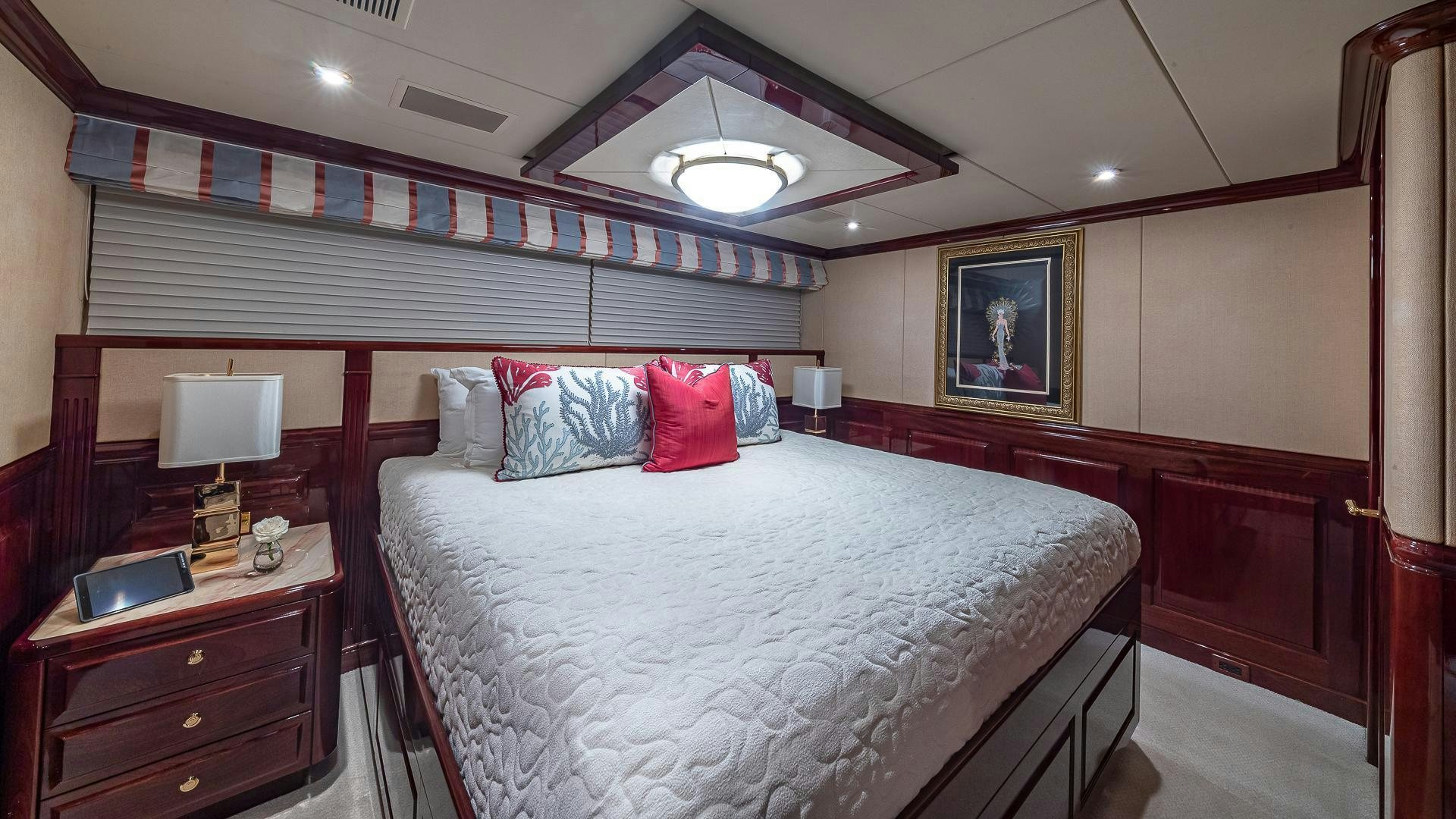 a bedroom with a bed and a desk aboard CASINO ROYALE Yacht for Sale