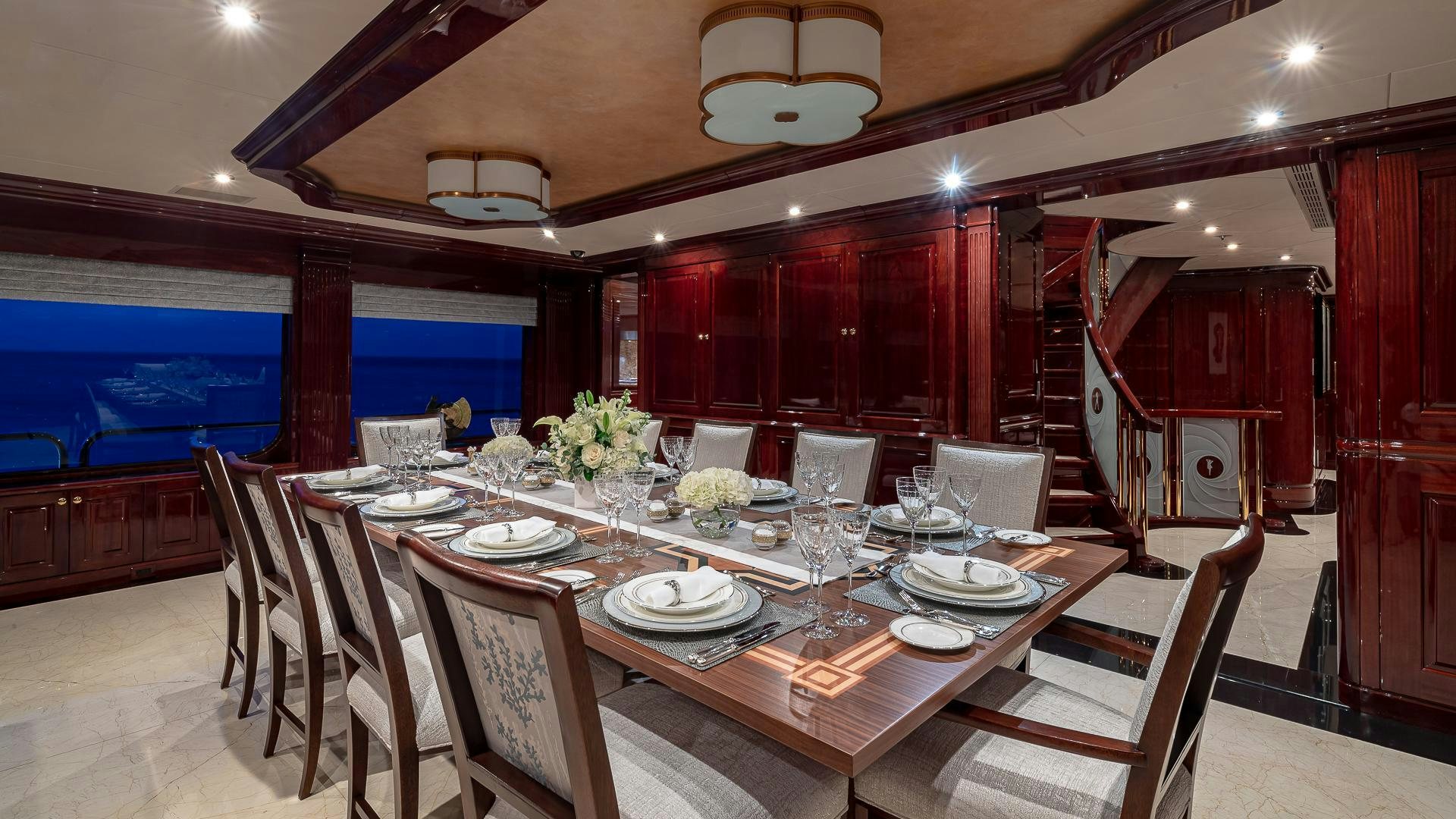 a dining room with tables and chairs aboard CASINO ROYALE Yacht for Sale