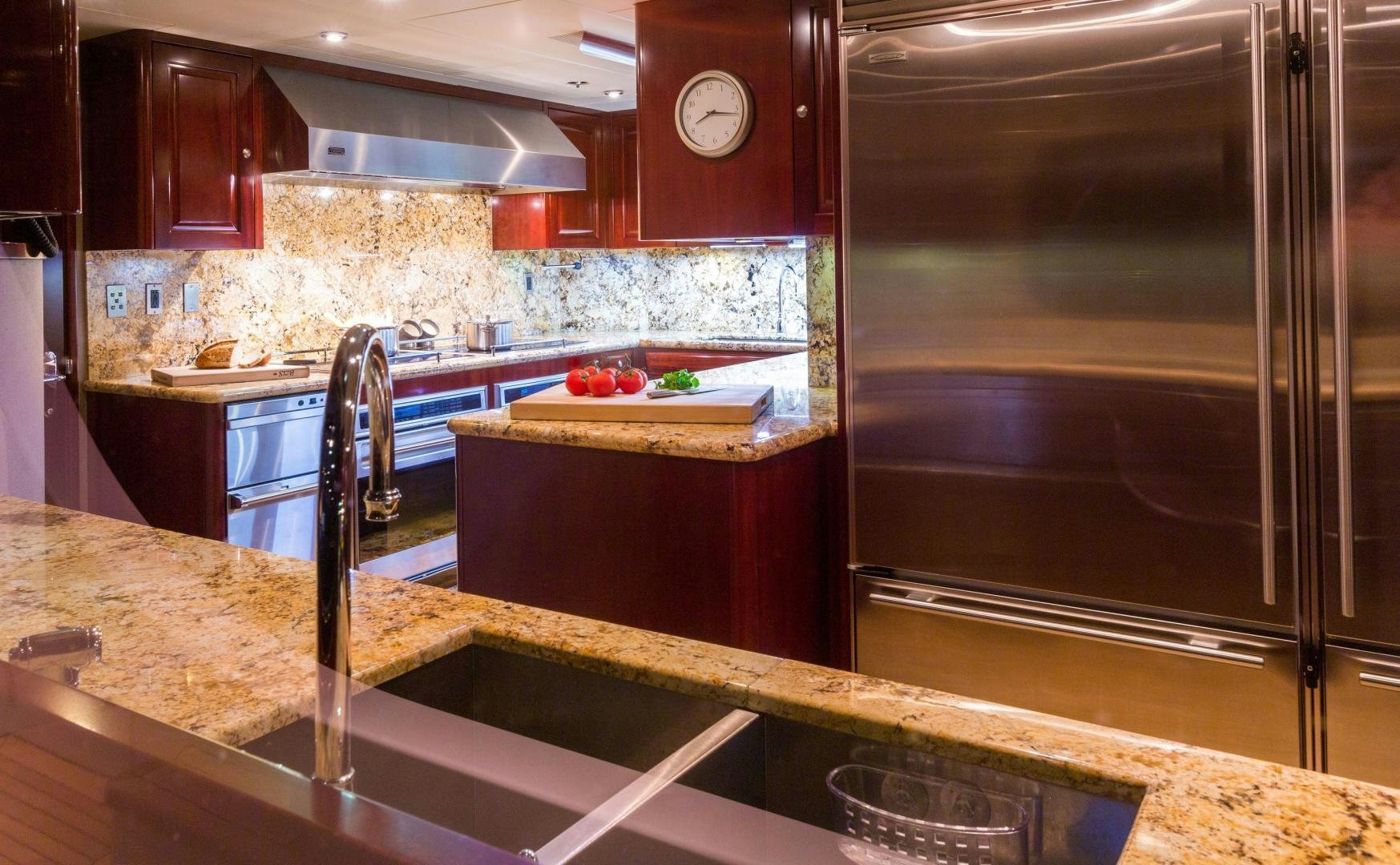 a kitchen with a stainless steel refrigerator aboard CASINO ROYALE Yacht for Sale
