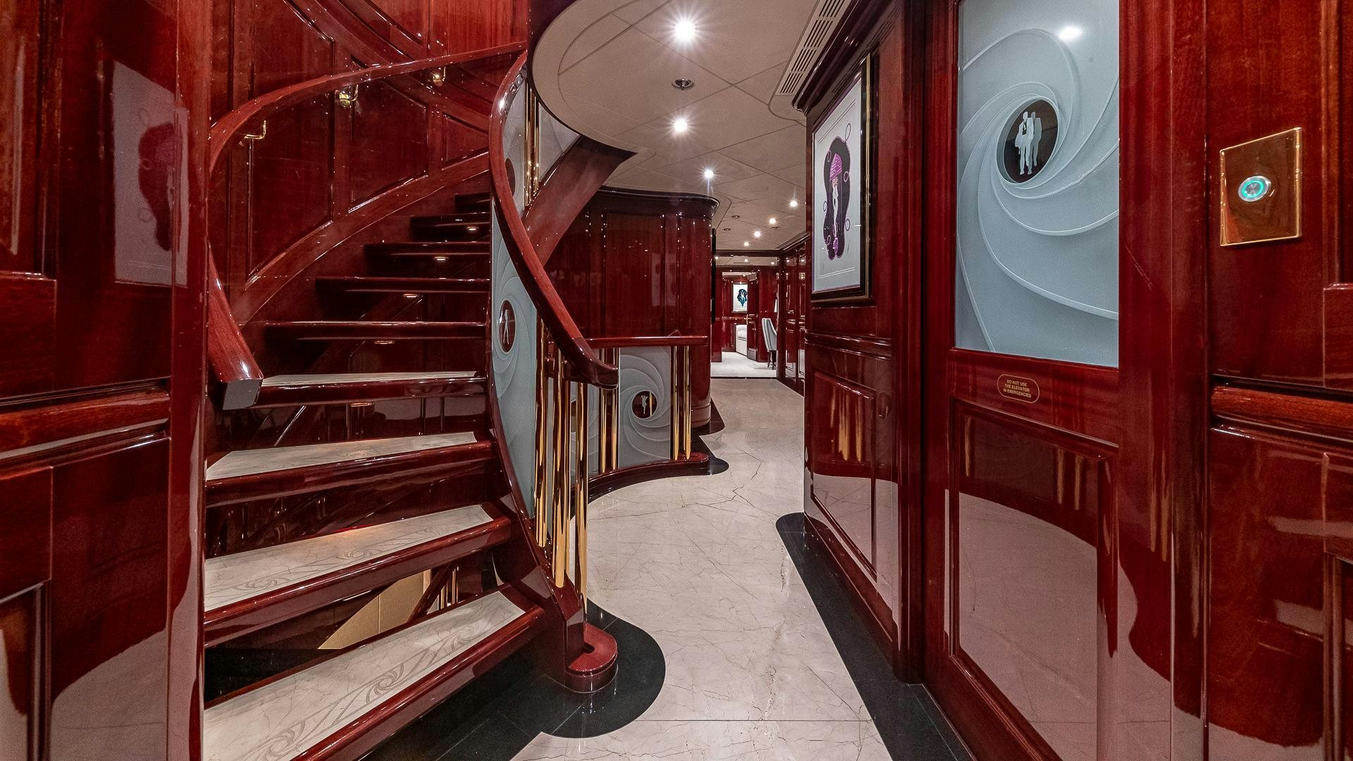 a hallway with red walls and a staircase aboard CASINO ROYALE Yacht for Sale