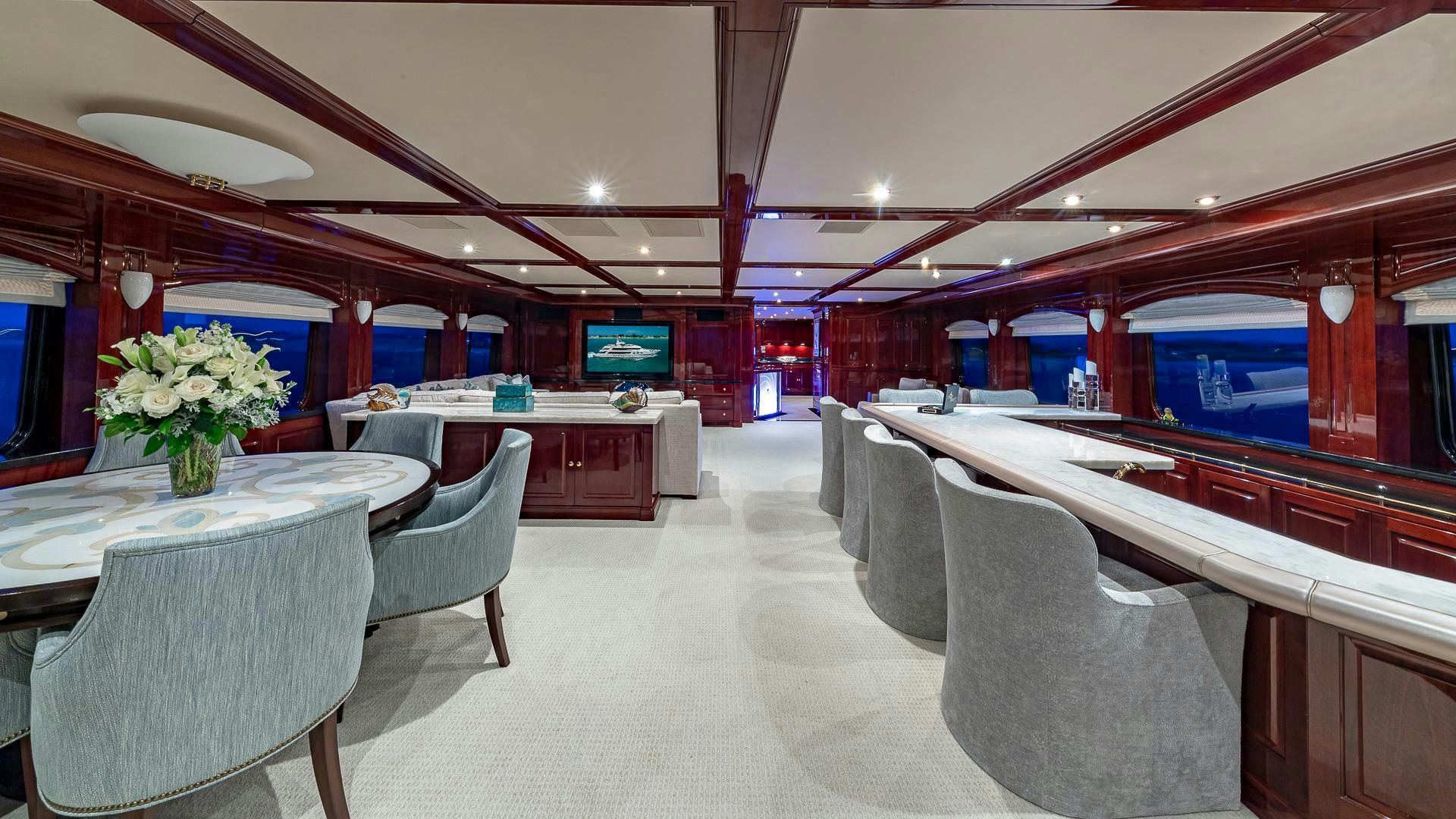 a room with tables and chairs aboard CASINO ROYALE Yacht for Sale
