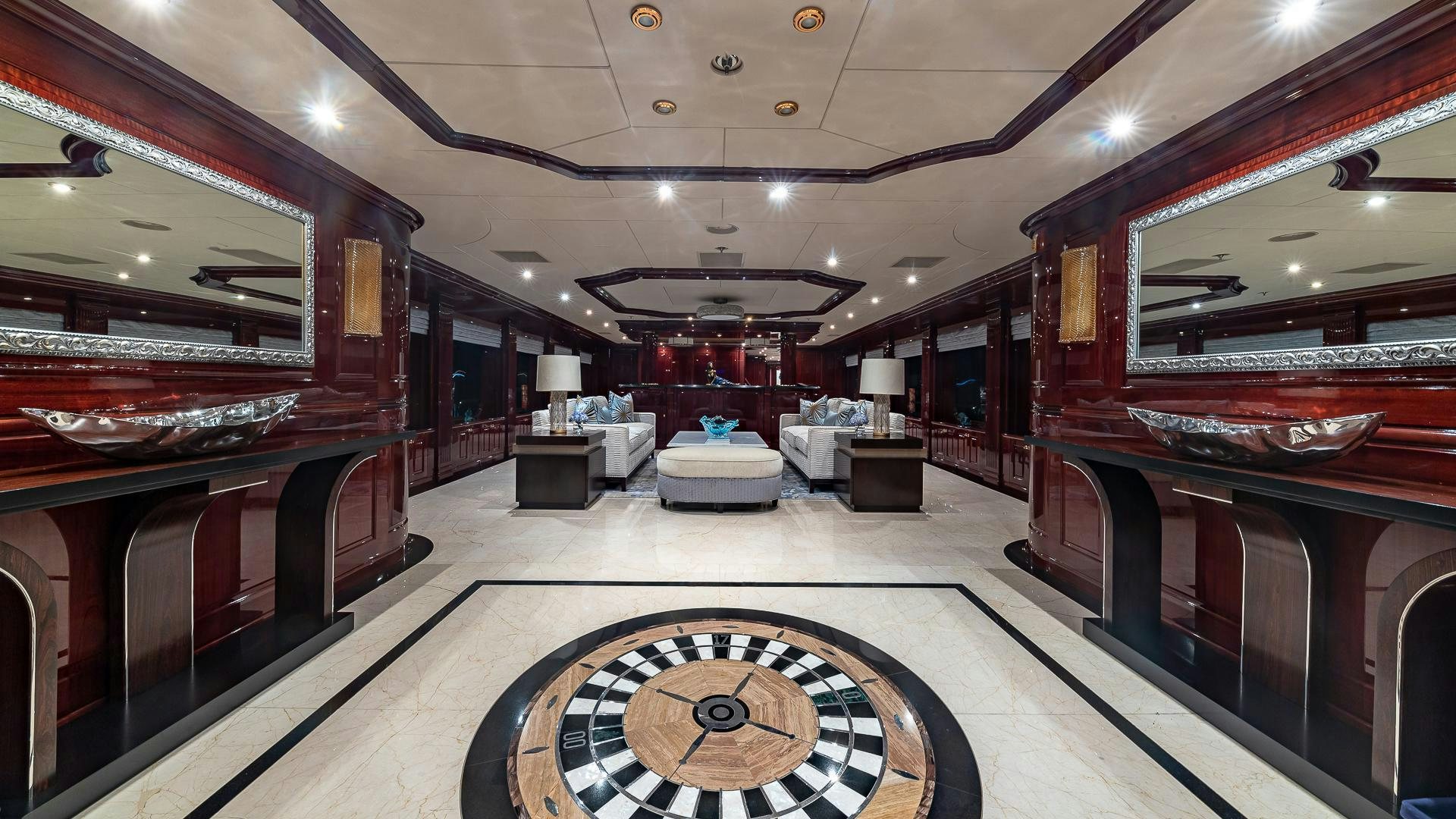 a room with a large mirror and a rug on the floor aboard CASINO ROYALE Yacht for Sale