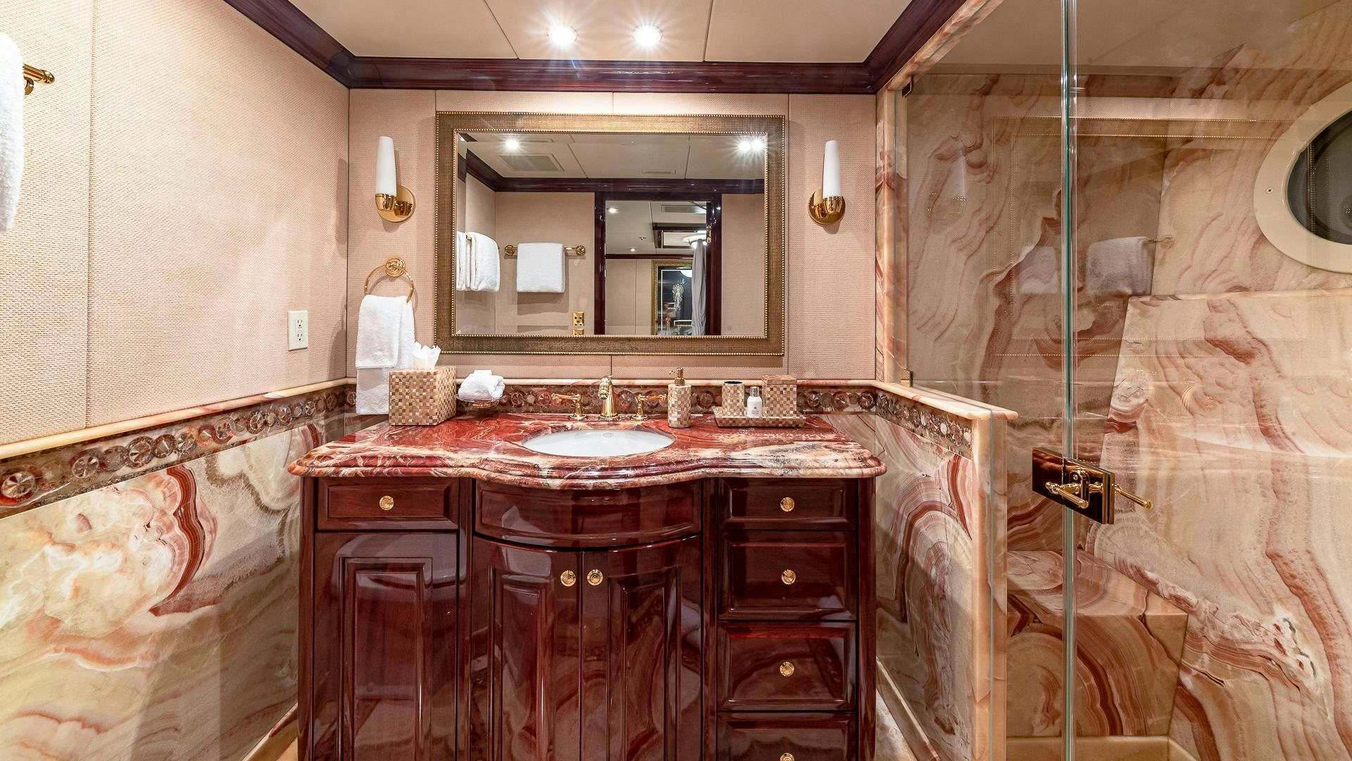 a bathroom with a sink and a mirror aboard CASINO ROYALE Yacht for Sale