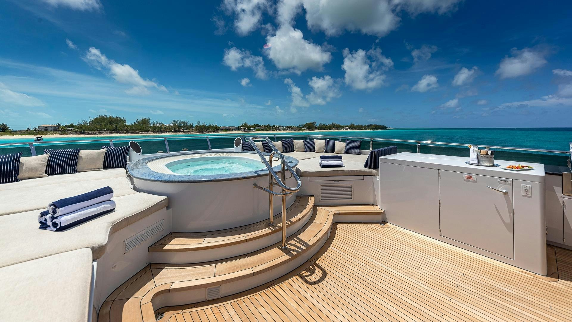 a large pool with a deck and a deck and a view of the water aboard CASINO ROYALE Yacht for Sale