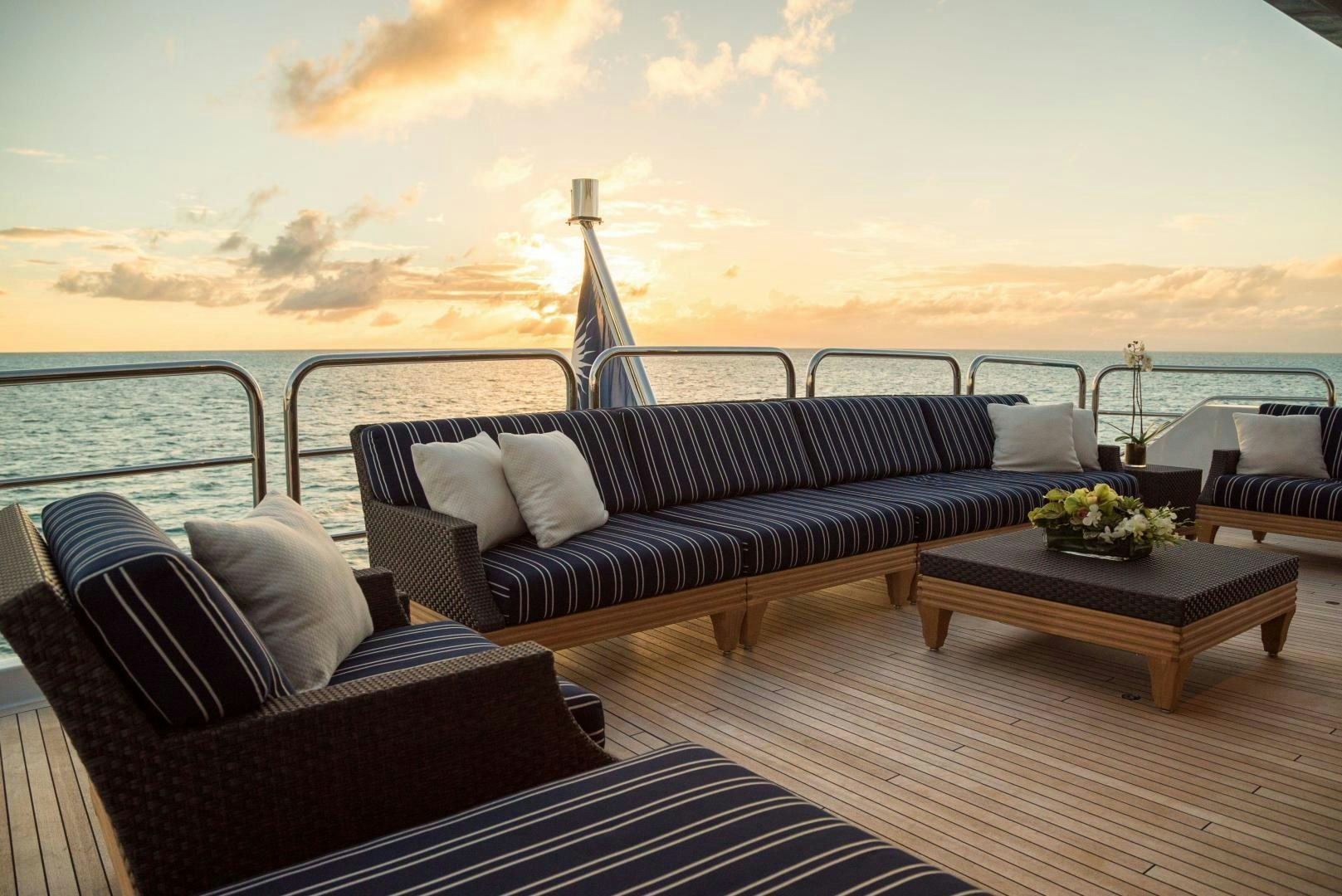 a room with couches and a table and a large body of water aboard CASINO ROYALE Yacht for Sale