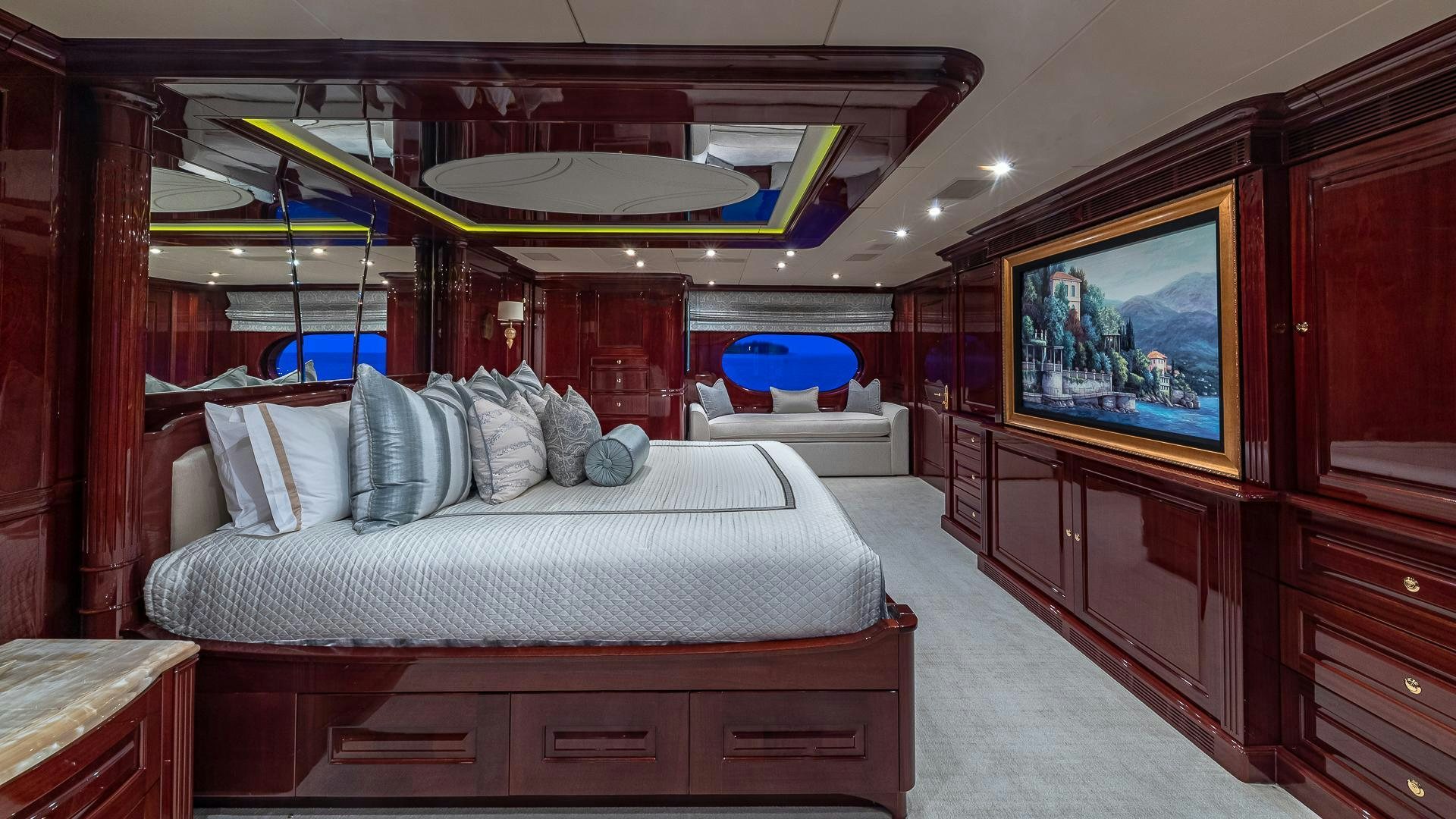 a bedroom with a bed and a television aboard CASINO ROYALE Yacht for Sale