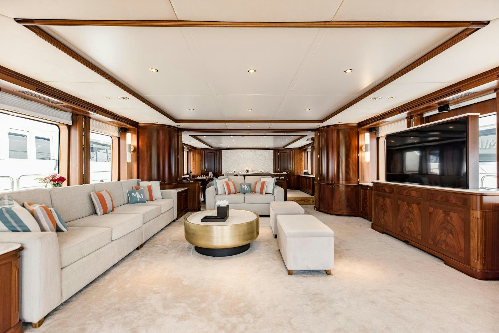 a living room with a large wood wall aboard MAMMA MIA Yacht for Sale