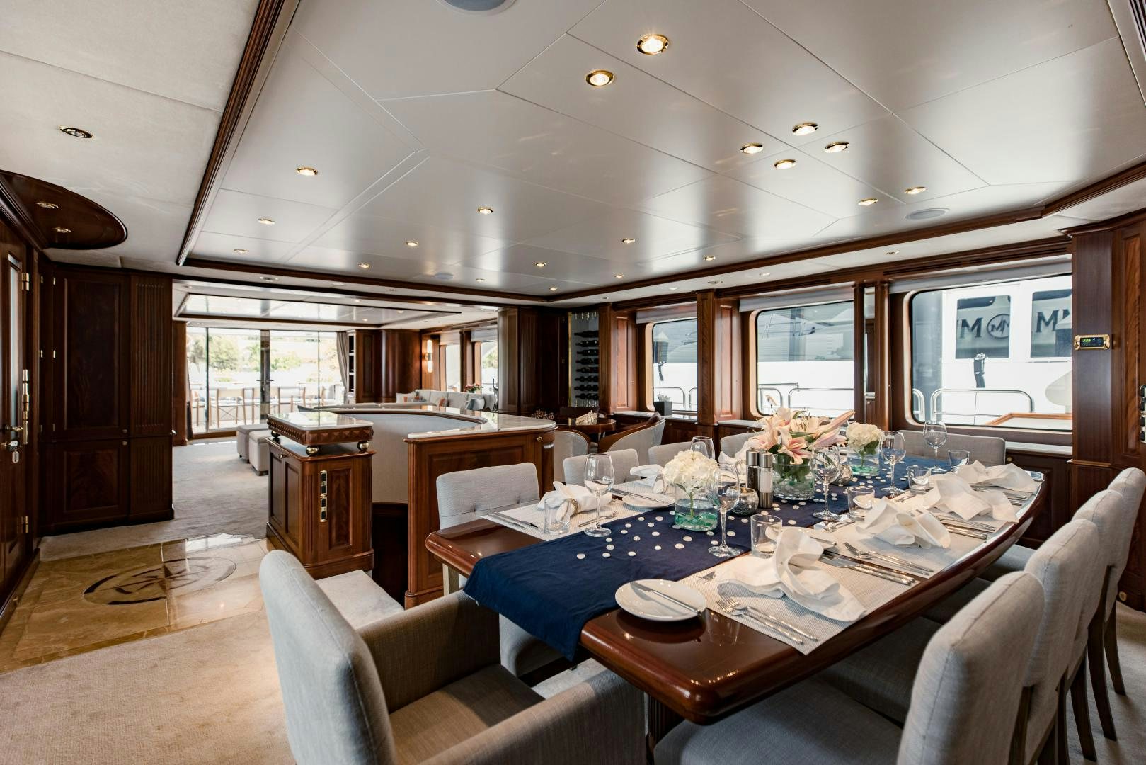 a large dining room with a kitchen and living room aboard MAMMA MIA Yacht for Sale