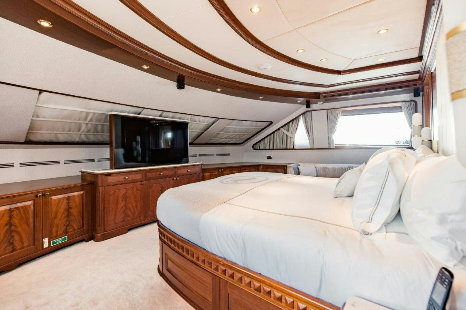 a bedroom with a bed and a television aboard MAMMA MIA Yacht for Sale