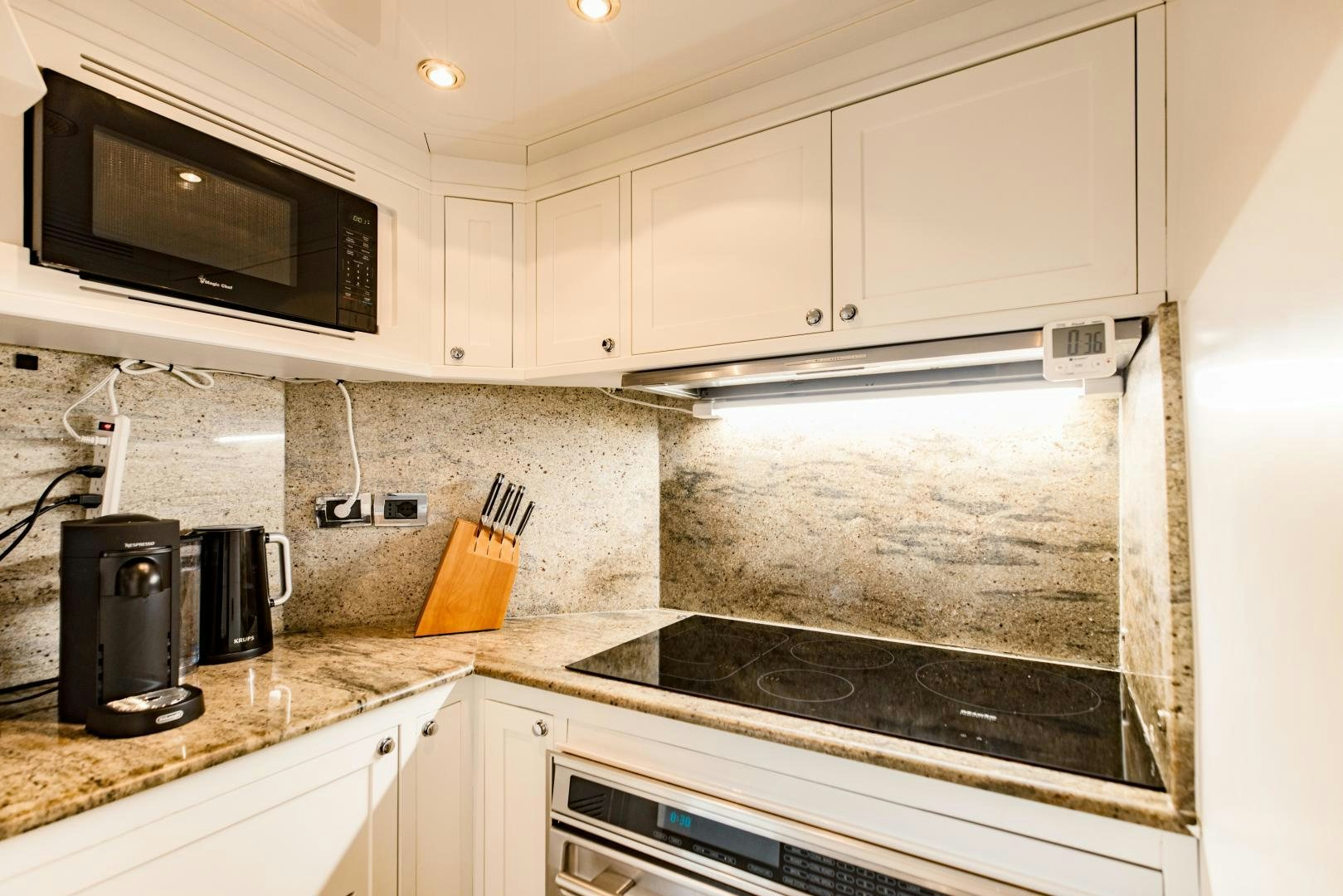 a kitchen with a microwave oven and a toaster oven aboard MAMMA MIA Yacht for Sale