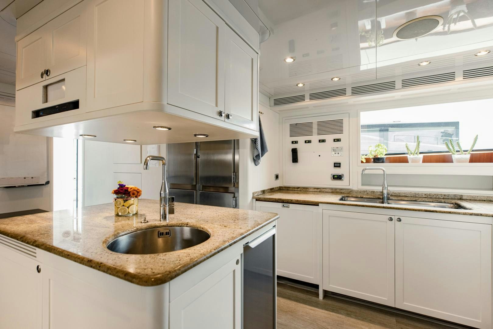 a kitchen with white cabinets aboard MAMMA MIA Yacht for Sale