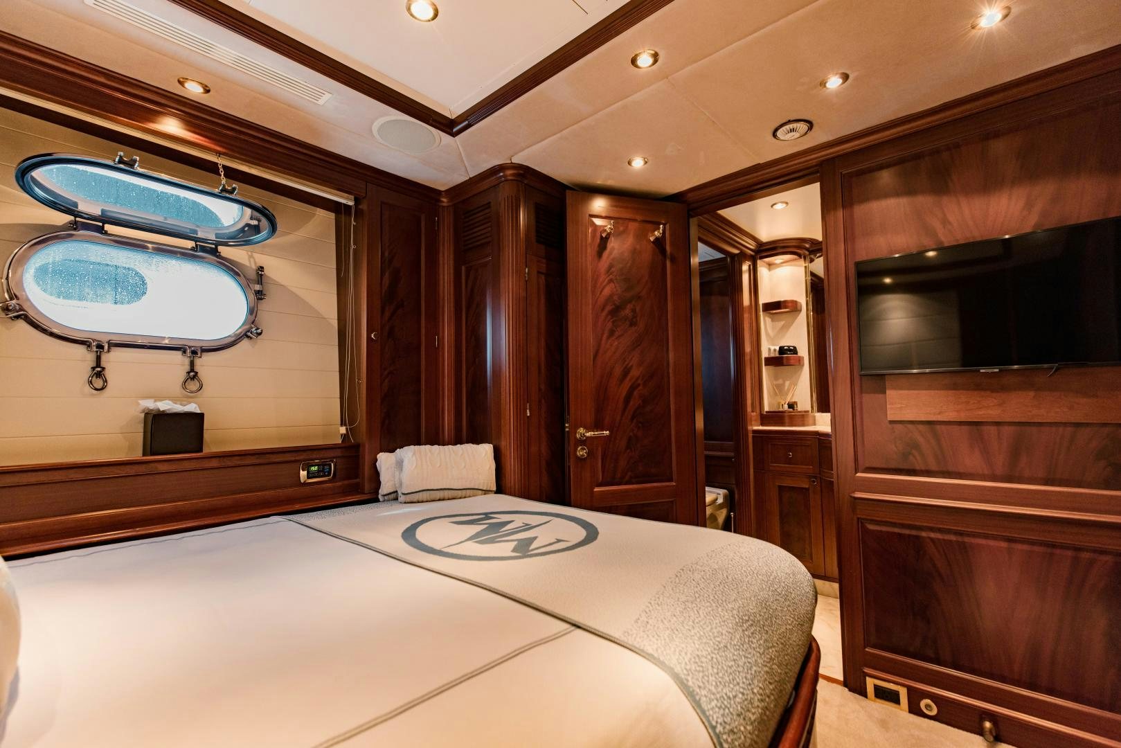 a bedroom with a large mirror aboard MAMMA MIA Yacht for Sale
