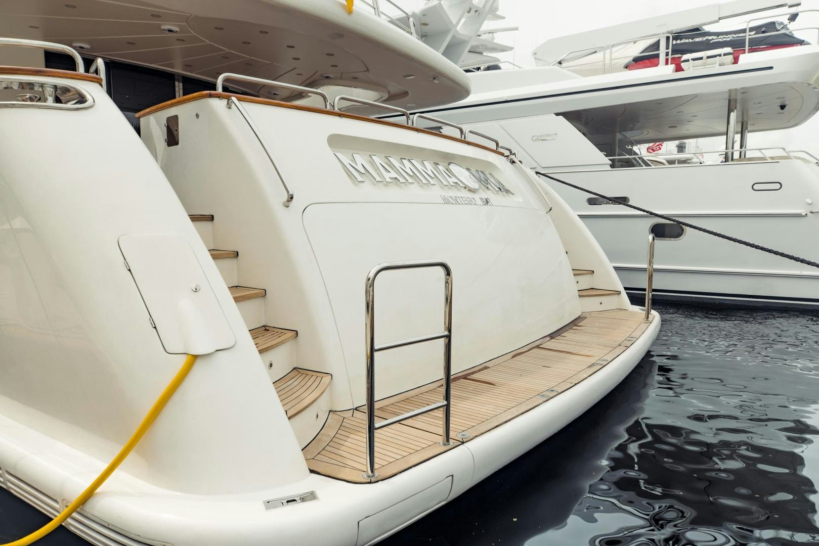 a white yacht on the water aboard MAMMA MIA Yacht for Sale