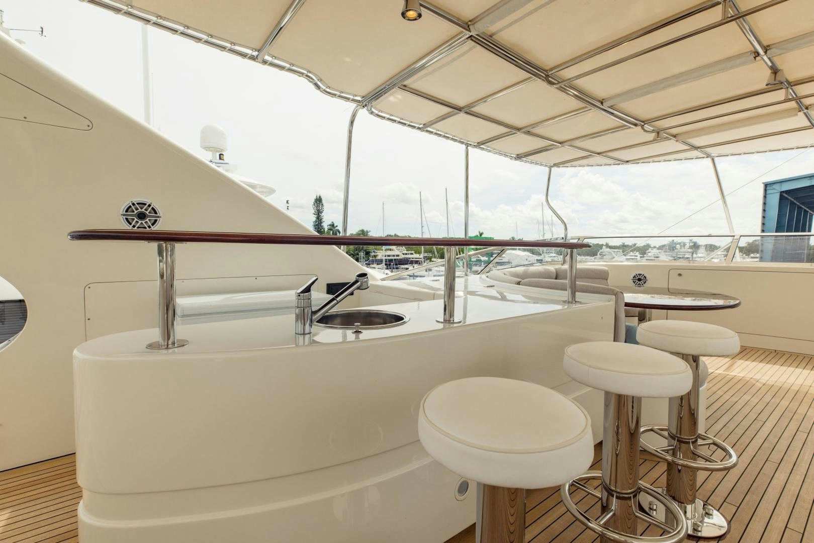a large white kitchen with stools aboard MAMMA MIA Yacht for Sale