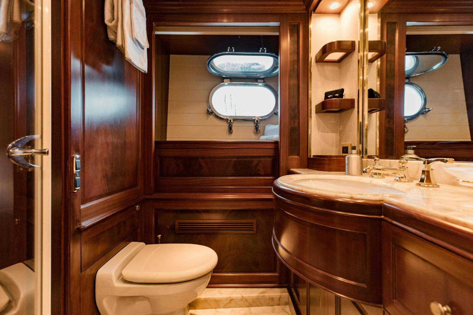 a bathroom with a toilet and a sink aboard MAMMA MIA Yacht for Sale