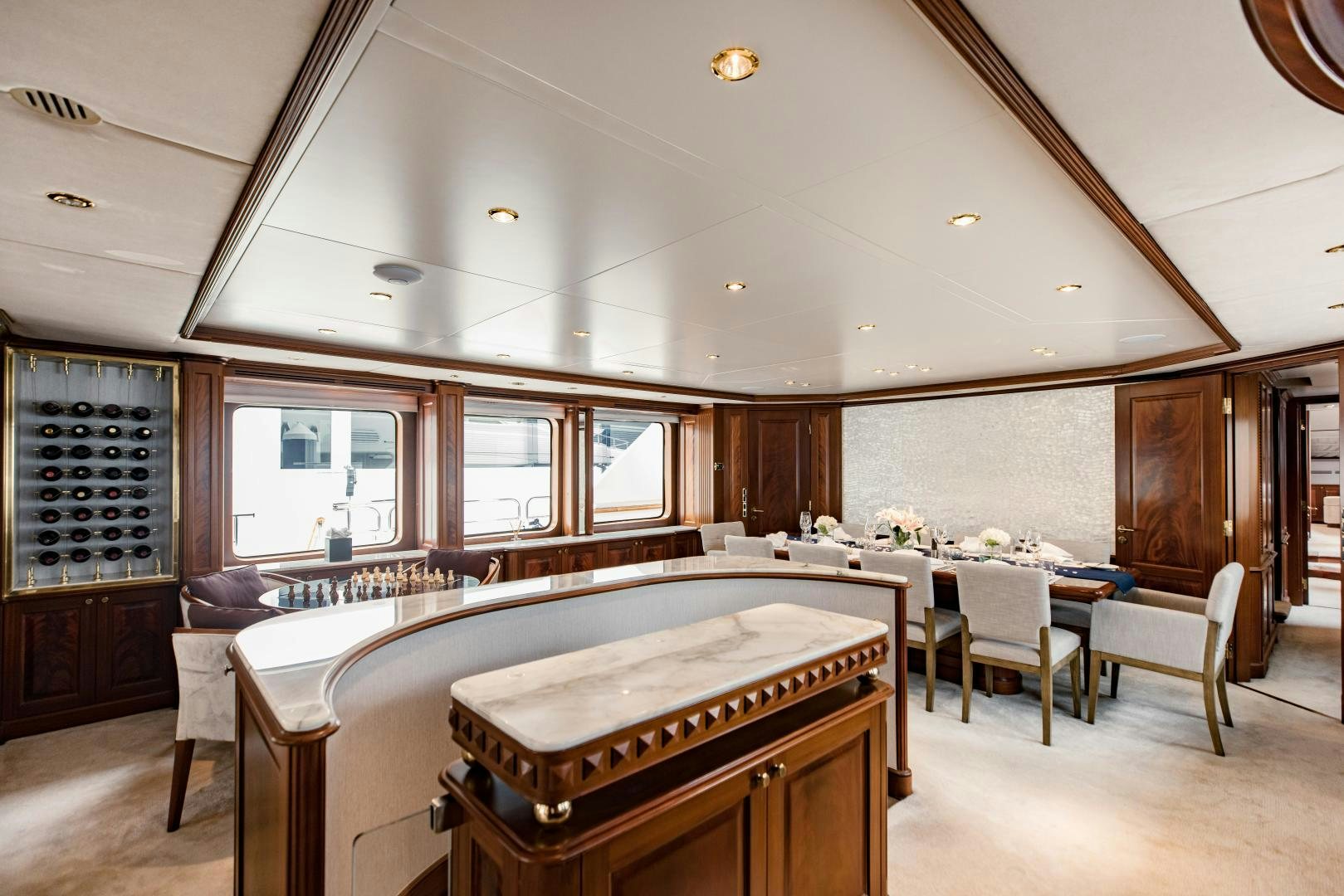 a large room with a bed and chairs aboard MAMMA MIA Yacht for Sale