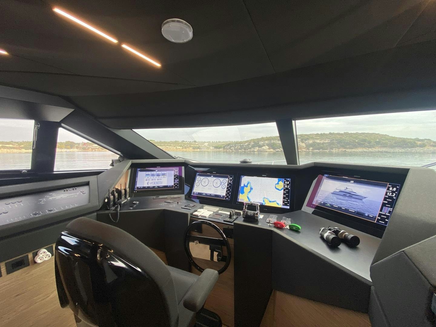 a room with many monitors and a chair aboard M/Y SUNRISE Yacht for Sale