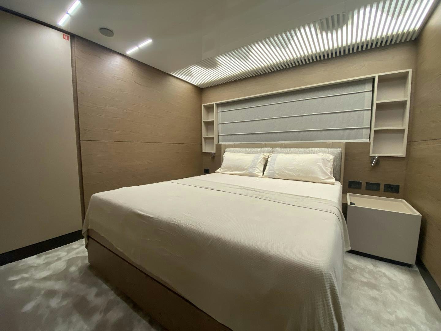 a room with a bed and a shelf aboard M/Y SUNRISE Yacht for Sale