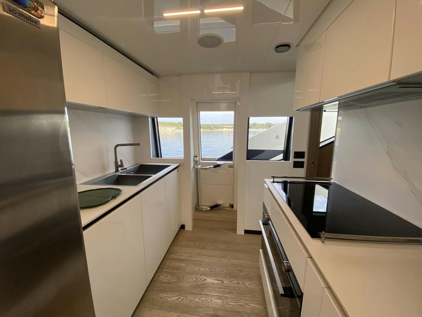 a kitchen with a large refrigerator aboard M/Y SUNRISE Yacht for Sale