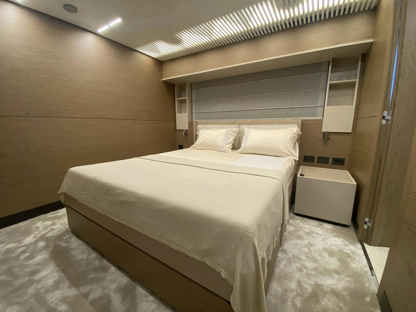 a room with a bed and a desk aboard M/Y SUNRISE Yacht for Sale