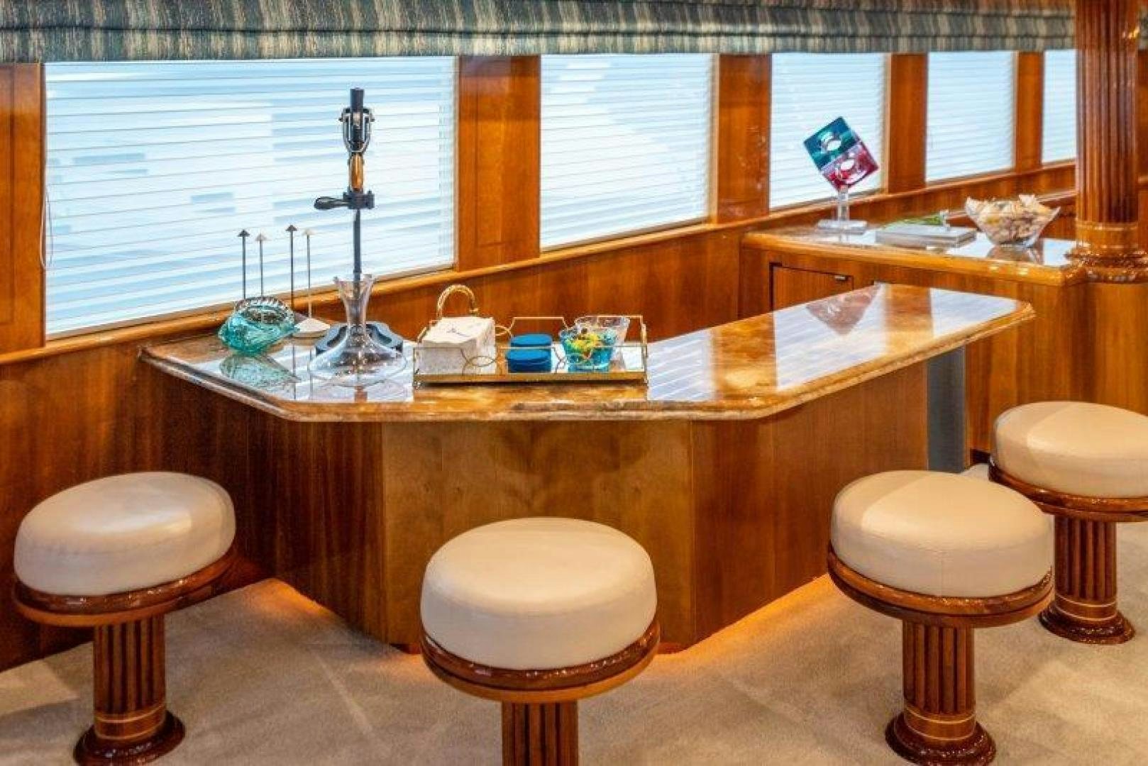a kitchen with a countertop sink and stools aboard TIE BREAKER Yacht for Sale