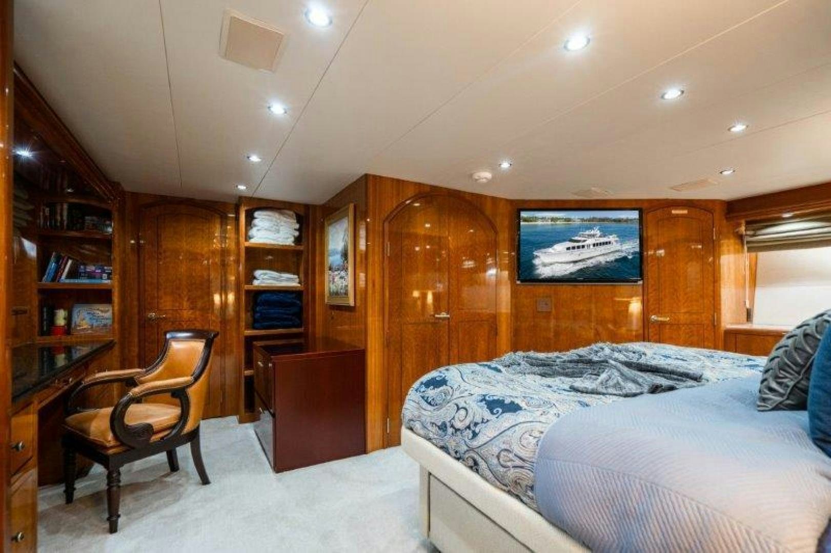 a bedroom with a bed and a desk aboard TIE BREAKER Yacht for Sale