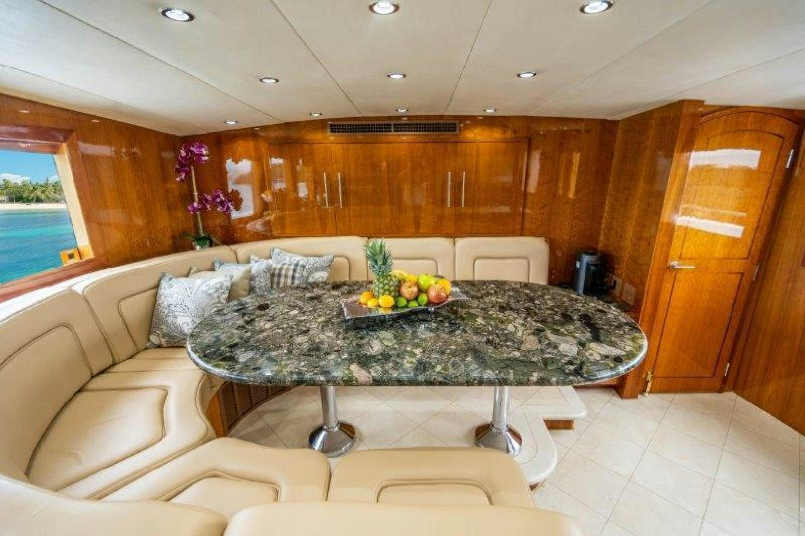 a living room with a table and couches aboard TIE BREAKER Yacht for Sale