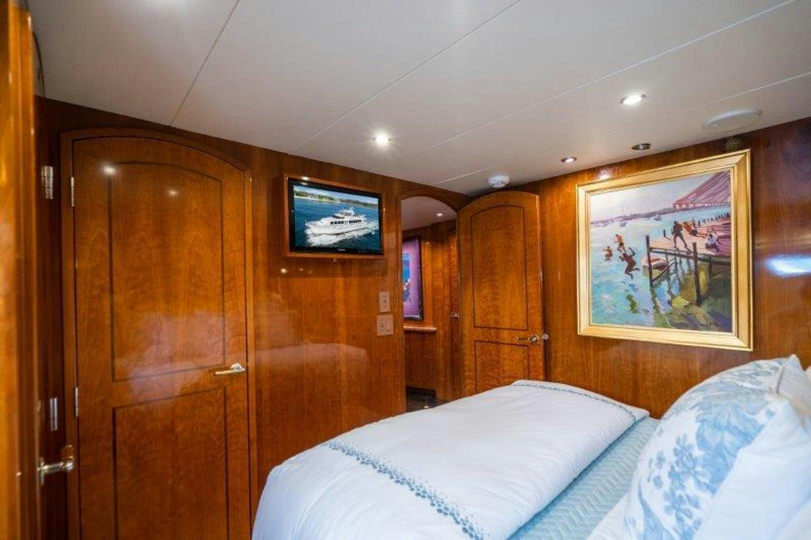 a room with a bed and a wood cabinet aboard TIE BREAKER Yacht for Sale