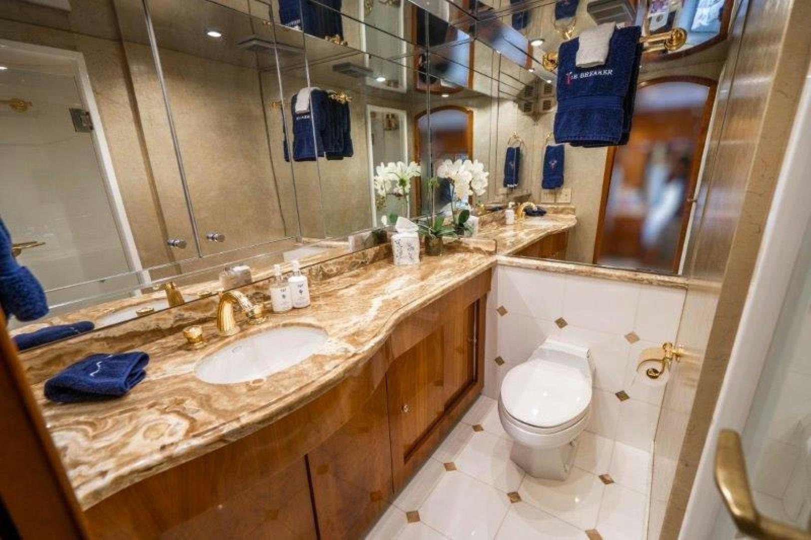 a bathroom with a sink toilet and a mirror aboard TIE BREAKER Yacht for Sale