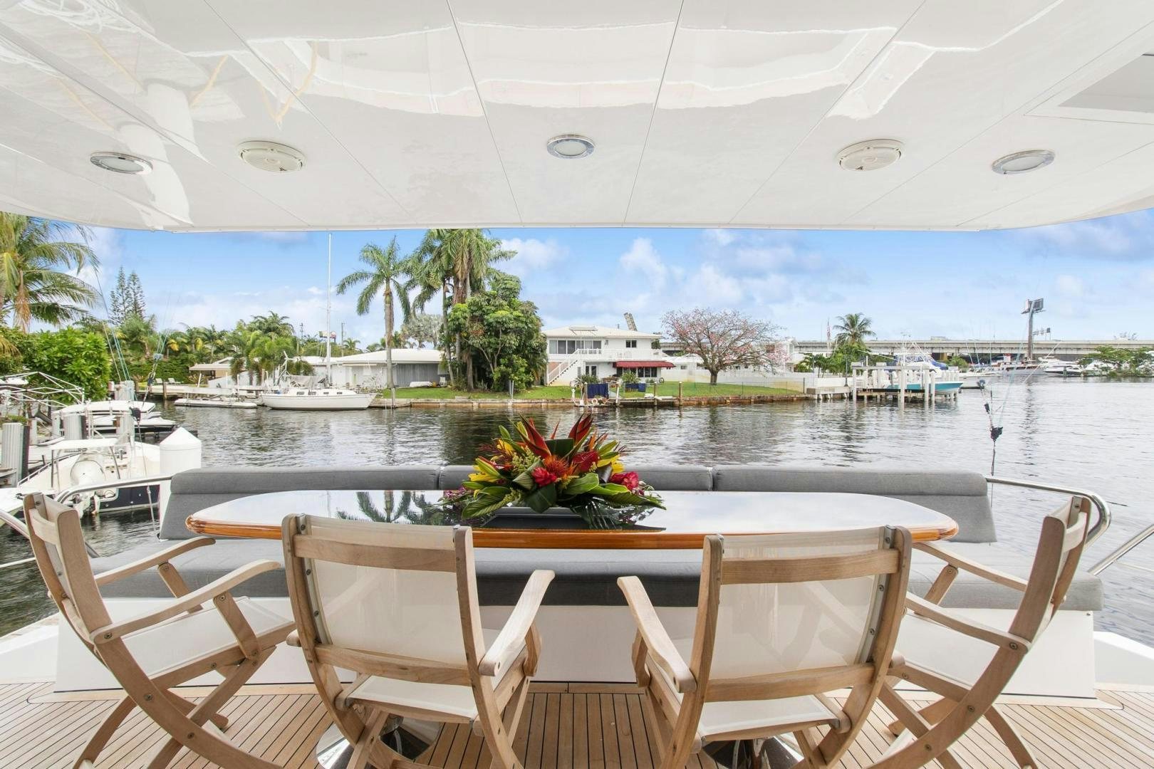 a table and chairs on a patio aboard BELLISSIMA Yacht for Sale
