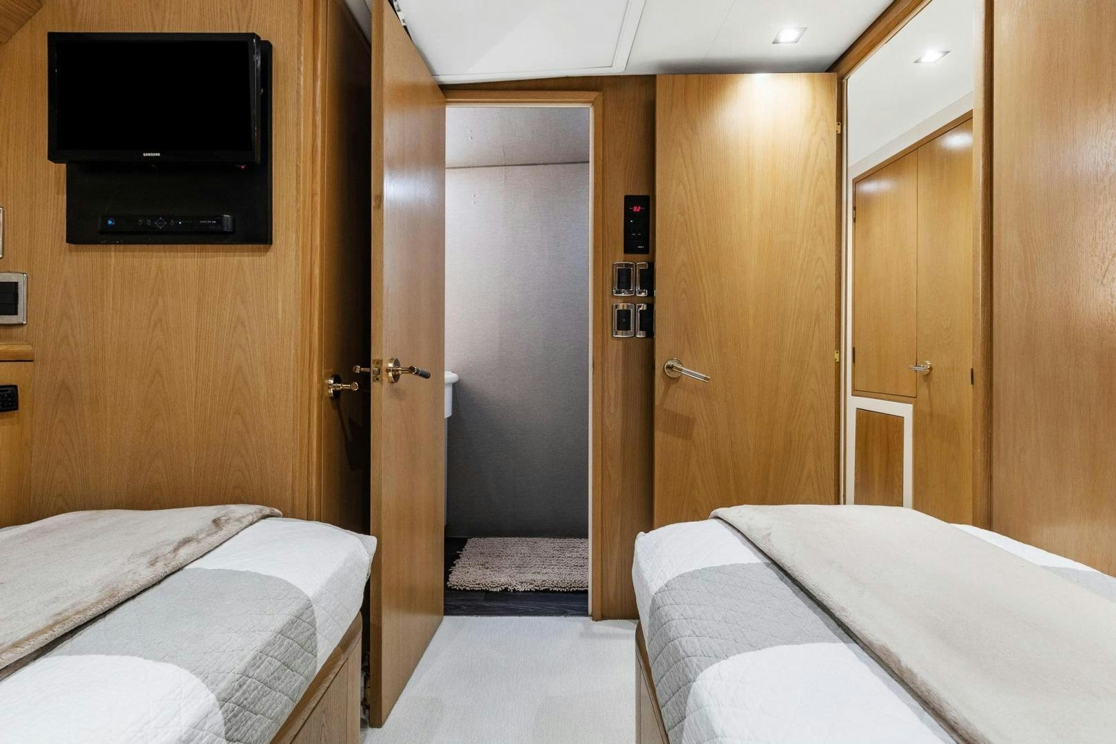 a hotel room with a bed and tv aboard BELLISSIMA Yacht for Sale