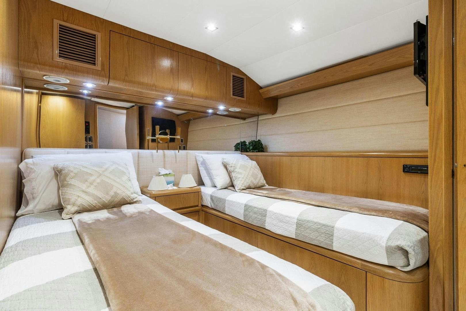 a room with a bed and a table aboard BELLISSIMA Yacht for Sale