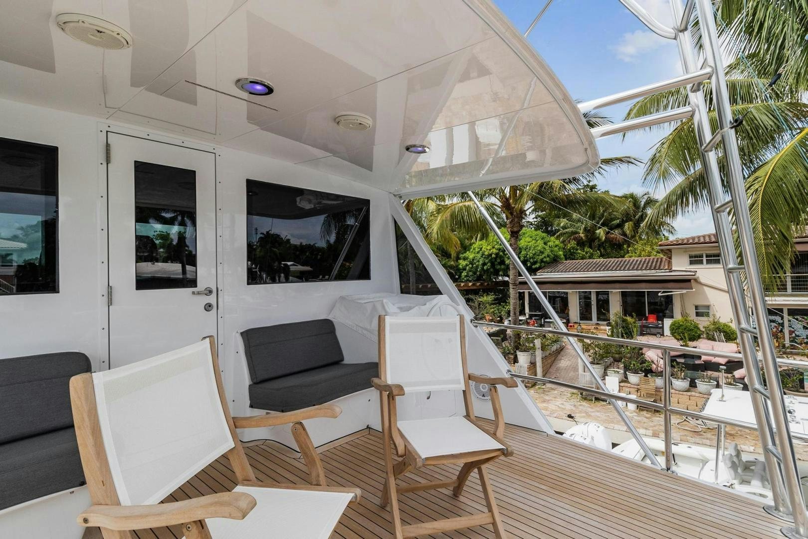 a deck with chairs and a table on it aboard BELLISSIMA Yacht for Sale