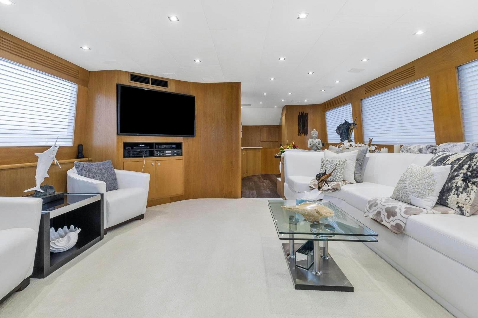 a living room with a large white sofa and a television aboard BELLISSIMA Yacht for Sale