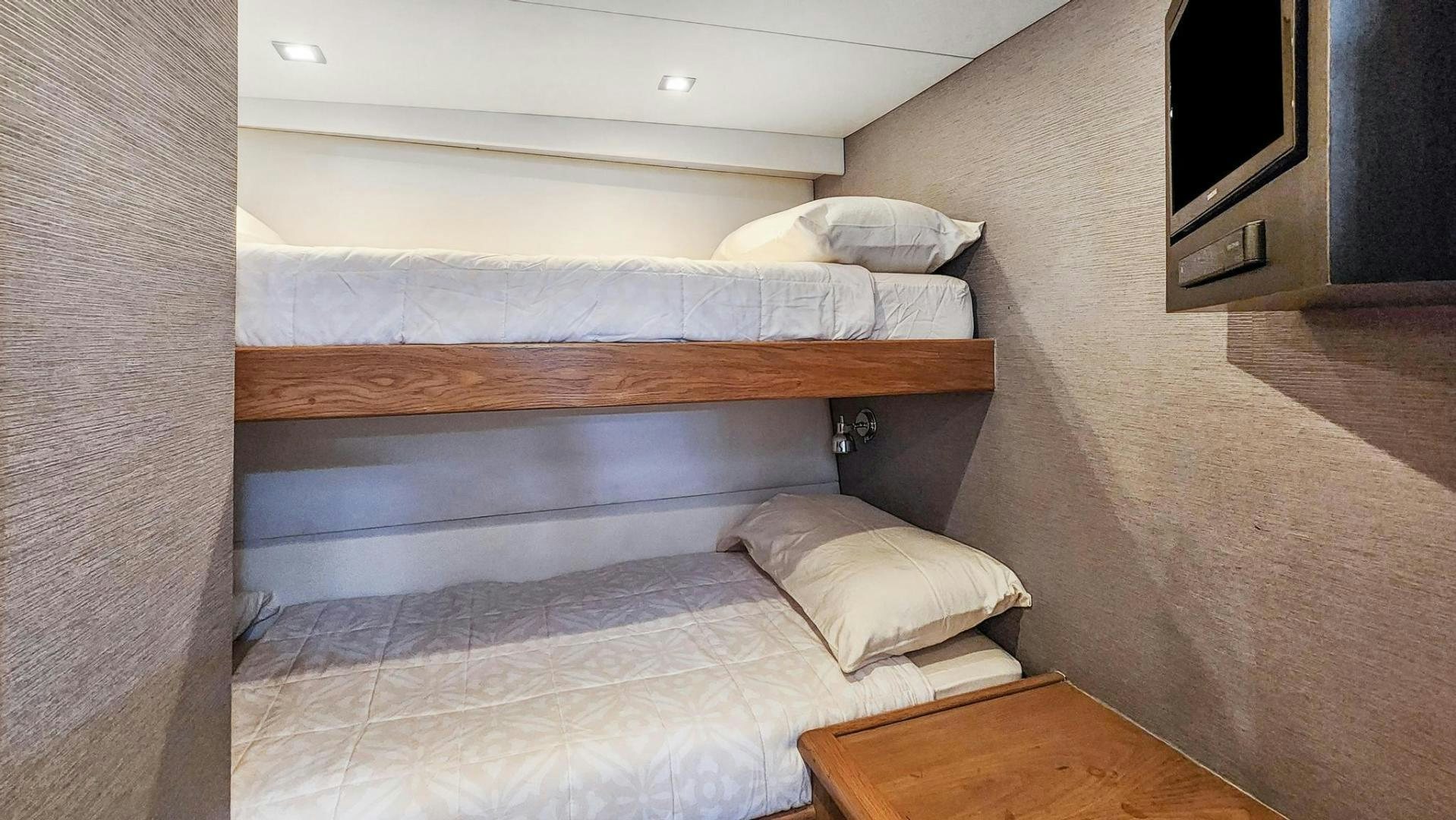 a bed with a wooden frame aboard BELLISSIMA Yacht for Sale
